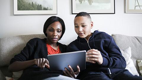Two people looking at tablet 